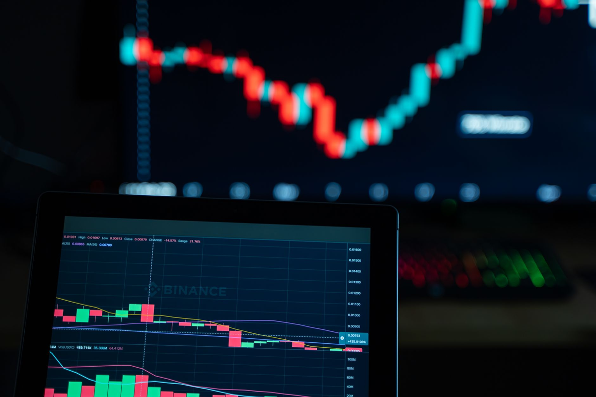 Detailed view of cryptocurrency trading charts on digital screens, showcasing market fluctuations.