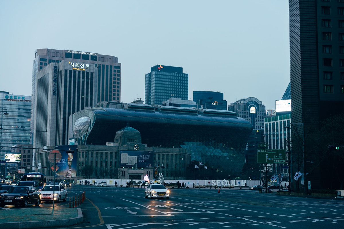 View of modern skyscrapers and streets in downtown Seoul, highlighting City Hall.